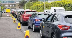  ?? PA WIRE ?? Cars queue to get into Blackstaff Way Recycling Centre in west Belfast yesterday and (right) a couple at Balloo Recycling Centre in Bangor