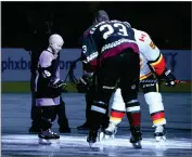  ?? AP PHOTO BY ROSS D. FRANKLIN ?? Leighton Accardo, left, who is battling cancer, drops the puck in front of Arizona Coyotes’ Oliver Ekman-larsson (23) and Calgary Flames’ Mark Giordano (5) during an NHL Fights Cancer puck drop ceremony prior to an NHL hockey game in Glendale, Ariz., in this Saturday, Nov. 16, 2019, photo.