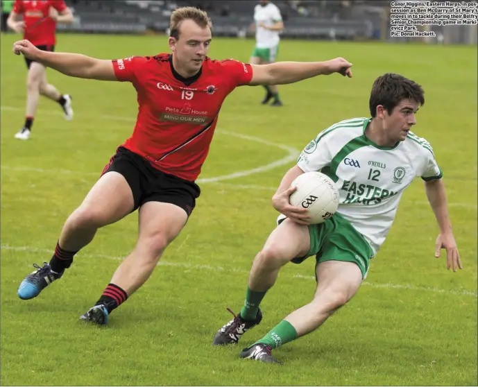  ??  ?? Conor Higgins, Eastern Harps, in possession as Ben McGarry of St Mary’s moves in to tackle during their Belfry Senior Championsh­ip game in Markievicz Park.
Pic: Donal Hackett.