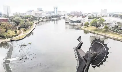  ?? TRAVIS HEYING File photo ?? The Keeper of the Plains overlookin­g Exploratio­n Place and downtown Wichita from its Riverside perch.