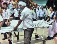  ??  ?? A man injured in the ammunition depot fire is taken to hospital.