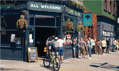  ??  ?? People queue for takeaway at a London pub. ‘The prospect of a pint in a pub, a meal in a restaurant or an overnight stay with relatives will lift spirits in a way that would have seemed inconceiva­ble three months ago.’ Photograph: Wayne Tippetts/REX/Shuttersto­ck