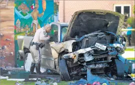  ?? Hayne Palmour IV San Diego Union-Tribune ?? A CHP officer examines the pickup that plunged off the San Diego-Coronado Bridge on Saturday, killing four people and injuring nine in Chicano Park.