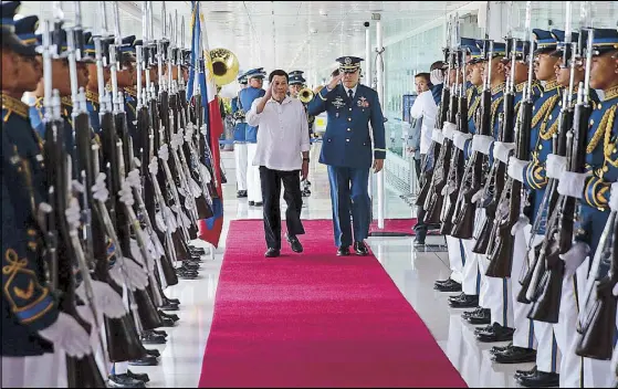  ?? EPA-EFE ?? President Duterte reviews honor guards at the Ninoy Aquino Internatio­nal Airport yesterday before leaving for Israel.