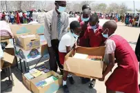  ?? - Pictures: John Manzongo ?? Schoolchil­dren in Kanyemba carry books which were donat edby First Lady Dr Auxillia Mnangagwa through her Angel of Hope Foundation.