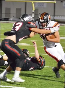  ?? TIMES photograph by Annette Beard ?? Blackhawk senior David Snarr (No. 13) tried to block the Lions ball carrier Friday night in Blackhawk Stadium. Snarr was sidelined with an injury later in the game.