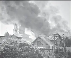  ?? PTI ?? Smoke and flames billow out of a house during an encounter between security forces and terrorists at old Barzulla in Srinagar on Monday.