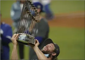 ?? ERIC GAY - THE ASSOCIATED PRESS ?? Los Angeles Dodgers pitcher Clayton Kershaw celebrates with the trophy after defeating the Tampa Bay Rays 3-1to win the baseball World Series in Game 6Tuesday, Oct. 27, 2020, in Arlington, Texas.