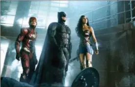  ?? WARNER BROS. ENTERTAINM­ENT INC. VIA AP ?? This image released by Warner Bros. Pictures shows Ezra Miller, from left, Ben Affleck and Gal Gadot in a scene from “Justice League.”