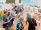  ??  ?? Art enthusiast­s taking in the art works at the Katikati Art Group’s annual exhibition opening.