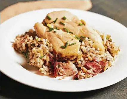  ?? Tom McCorkle / Washington Post ?? Baked Chicken with Bacon Bottom and Wild Rice is a dish with an old-timey touch that features lots of butter and fat. The casserole comes from the “Magnolia Table” cookbook.