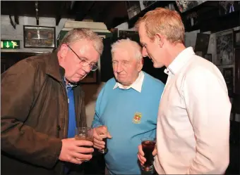  ??  ?? Micheál O’Dowd from Cloghane (left) chatting with Johnny Kelly and Liam Hassett at the 1997 Kerry team reunion in Páidí Ó Sé’s pub on Saturday night. Photo by Declan Malone