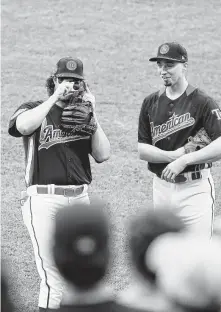  ?? Patrick McDermott / Getty Images ?? Astros pitcher Gerrit Cole, left, with the Rays’ Blake Snell, snaps a momento during Monday’s All-Star workout at Nationals Park. Cole is an All-Star for the second time.