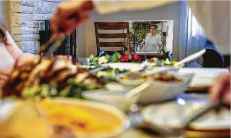  ?? John Minchillo / Associated Press ?? An image of Ana Martinez, the recently deceased mother of sisters Vivian Zayas and Alexa Rivera, rests at the head of the table.