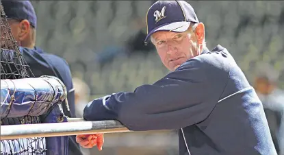  ?? MICHAEL SEARS / JOURNALSEN­TINEL ?? Top: Brewers manager Ron Roenicke keeps an eye on batting practice the day before the home opener in April.