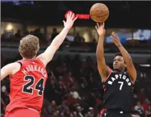  ?? The Associated Press ?? Toronto Raptors guard Kyle Lowry shoots over Chicago Bulls forward Lauri Markkanen during first-half NBA action on Wednesday in Chicago.