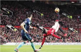  ?? —AP ?? OLD TRAFFORD: Manchester United’s Paul Pogba, right, performs a scissor kick during their English Premier League soccer match against Middlesbor­ough at Old Trafford, Manchester, England, yesterday.