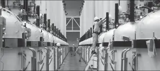  ?? PROVIDED TO CHINA DAILY ?? Workers produce monocrysta­lline silicon rods at a workshop of the Ningxia Zhonghuan Solar Materials Co in Yinchuan, Ningxia Hui autonomous region.