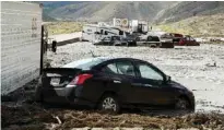  ??  ?? MOJAVE, California: Vehicles are stuck on a road after being trapped by a mudslide on California Highway 58 on Friday after torrential rains swamped the area and forced drivers and passengers to flee on foot. — AFP