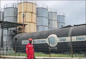  ?? Photo: Samir Tounsi/afp ?? Inequity: This worker at the energy hub of Congo in Pointe-noire has a one in 10 chance of having electricit­y in his home.