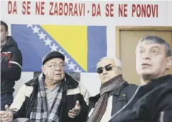  ??  ?? 0 Bosnians in the town of Mostar watch footage from the trial