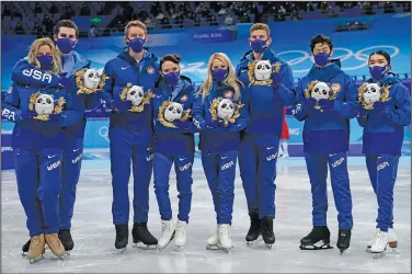  ?? Associated Press ?? Medal ceremony delayed: Silver medalists Team United States stand pose for a group photo following the victory ceremony after the team event in the figure skating competitio­n at the 2022 Winter Olympics Monday in Beijing.