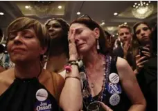  ?? DAVID GOLDMAN/THE ASSOCIATED PRESS ?? Jan Yanes, centre, cries as Democratic candidate for 6th Congressio­nal District Jon Ossoff concedes to Republican Karen Handel on Tuesday.