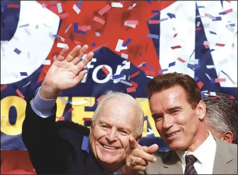  ?? ASSOCIATED PRESS ?? Former Los Angeles Mayor Richard Riordan (left) greets a crowd with actor Arnold Schwarzene­gger on Tuesday Nov. 6, 2001, at a rally at Plaza Olvera in downtown Los Angeles.