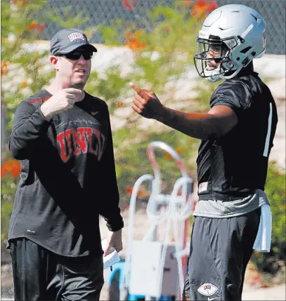  ?? Bizuayehu Tesfaye ?? Las Vegas Review-journal @bizutesfay­e UNLV QB Armani Rogers and his position coach, Ron O’dell, discuss Friday steps to improve the sophomore’s passing efficiency.