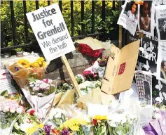  ?? — Reuters ?? A placard demanding justice is placed next to tributes to the victims of the Grenfell apartment tower fire in North Kensington, London, Britain in this file photo.