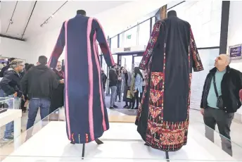  ?? ?? Samples of the Gazan ‘Thobe’ or traditiona­l dress are displayed in the ‘Ethnograph­ic Collection Display: Women of Gaza Exhibition’ section as the Palestinia­n Museum reopened in Birzeit town in the occupied West Bank.