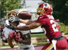  ?? STEVE HELBER — THE ASSOCIATED PRESS FILE ?? File-This file photo shows Washington Redskins cornerback Orlando Scandrick, right, breaking up a pass intended for wide receiver Josh Doctson at NFL football training camp in Richmond, Va. The Washington Redskins have released Scandrick. Coach Jay Gruden confirmed the move Tuesday before the final practice of training camp.