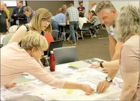  ?? Michael Burchfiel/Siloam Sunday ?? Participan­ts at a public workshop were asked to organize the amenities at the proposed Medical Springs Park. CARBO, the firm in charge of the park’s design, will take that feedback and hold a second meeting on June 22.