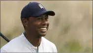  ?? MARK LENNIHAN — THE ASSOCIATED PRESS ?? Tiger Woods smiles after teeing off on the 12th hole in the Northern Trust at Liberty National Golf Course on Aug. 8in Jersey City, N.J.