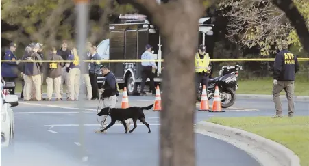  ?? AP PHOTO ?? ‘CreepY’: officials investigat­e the scene of the latest bombing in austin, texas, yesterday. police said sunday’s explosion was triggered by a nearly invisible tripwire, increasing the fear among residents.