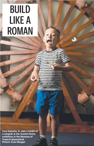  ??  ?? Luca Esposito, 6, uses a model of a catapult at the Ancient Rome exhibition at the Museum of Tropical Queensland.
Picture: Evan Morgan