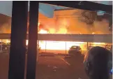  ?? COURTESY OF ORLANDO CHAVEZ ?? Flames engulf a carport early Friday at the Villa Apartments near Gibson and San Pedro. Orlando Chavez snapped the picture before his building was evacuated. “Seeing this, I was in awe,” he said.