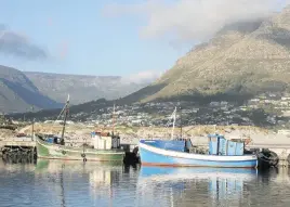  ??  ?? SCENE OF POACHING CRIMES. Fishing boats in Hout Bay, Cape Town.