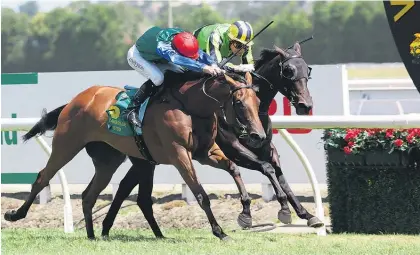  ?? Picture / Trish Dunell ?? Bonneval (red cap) gets the better of stablemate Nicoletta in the $100,000 Fillies Classic at Te Rapa