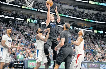  ?? ?? DELIVERING AGAIN: Mavericks guard Luka Doncic goes for a basket during the third quarter during Game Six of the first round play-off series against the Clippers at American Airlines Center.