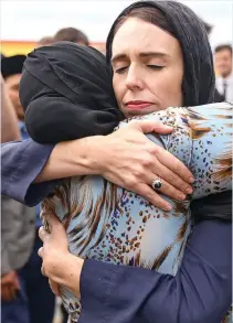  ??  ?? Comfort: Jacinda Ardern and mourner in Wellington NEW Zealand’s prime minister embraced worshipper­s at a mosque yesterday as they mourned the victims of Friday’s shooting.Jacinda Ardern appeared visibly moved as she greeted and hugged members of the Muslim community at the Kilbirnie mosque in the capital Wellington.Dressed in a black headscarf, she laid a floral tribute to the 50 killed in Brenton Tarrant’s massacre, the worst terror atrocity in the country’s history.A makeshift memorial to the dead was also set up outside the Al Noor mosque in Christchur­ch, the site of the first and deadliest attack. The death toll there rose from 41 to 42 on Saturday when a further victim was found among the carnage.Miss Ardern earlier revealed that