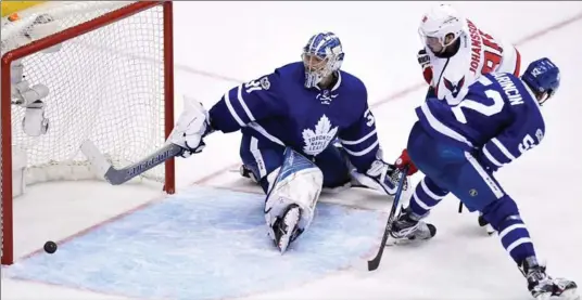  ?? FRANK GUNN, THE CANADIAN PRESS ?? Washington Capitals centre Marcus Johansson beats Maple Leafs goalie Frederik Andersen for the game and series winner in the first overtime period Sunday night. It was his second of the contest.