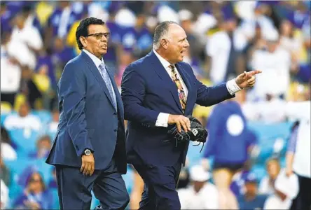  ?? Ryan Sun Associated Press ?? MIKE SCIOSCIA, right, says Fernando Valenzuela had the best stuff of any pitcher he ever caught while they played on the Dodgers. “When he was young, he could do so many things with a baseball,” he said. Scioscia also is pleased the Dodgers retired Valenzuela’s number.