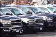  ?? David Zalubowski / Associated Press ?? A long row of unsold 2020 pickup trucks sits at a Ram dealership on Dec. 27 in Littleton, Colo. A new government report says gas mileage for new vehicles dropped and pollution increased in model year 2019 for the first time in five years.