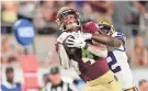  ?? GETTY IMAGES ?? Florida State receiver Keon Coleman catches a pass against LSU’s Duce Chestnut at Camping World Stadium on Sept. 3, 2023.