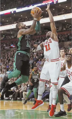  ?? AP PHOTO ?? ELEVATOR: Kyrie Irving goes to the basket over David Nwaba for two of his 25 points during the second quarter of the Celtics’ 117-92 win against the Chicago Bulls last night at the Garden.