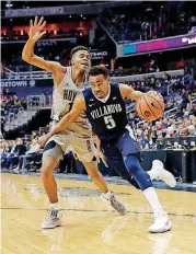  ?? [AP PHOTO] ?? Villanova guard Phil Booth (5) drives past Georgetown forward Jamorko Pickett (1) during the first half of Villanova’s victory on Wednesday in Washington, D.C.