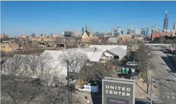  ?? SCOTT OLSON/GETTY IMAGES ?? The COVID-19 vaccinatio­n center being constructe­d in a parking lot at the United Center will begin taking registrati­ons today and is expected to be distributi­ng vaccines next week.