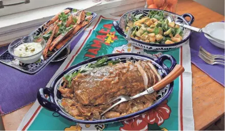  ?? ANGELA PETERSON, MILWAUKEE JOURNAL SENTINEL ?? Caribbean crock pot pork, sweet potato wedges with lime mayo and roasted pineapple avocado salad bring tropical flavors to the table.
