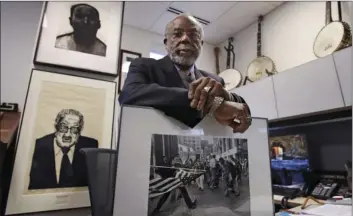  ?? AP PHOTO/CHARLES KRUPA ?? Theodore Landsmark, lawyer, architect and director of the Dukakis Center for Urban and Regional Policy at Northeaste­rn University poses for a photo in his office in Boston on Tuesday. Pictured in Landsmark’s office are a sketch of King, top left, a...